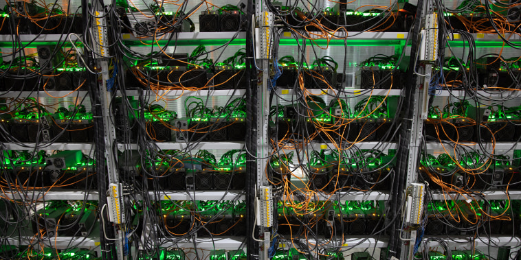 Image: Power and ethernet cables connected to mining rigs at a cryptocurrency mining center.