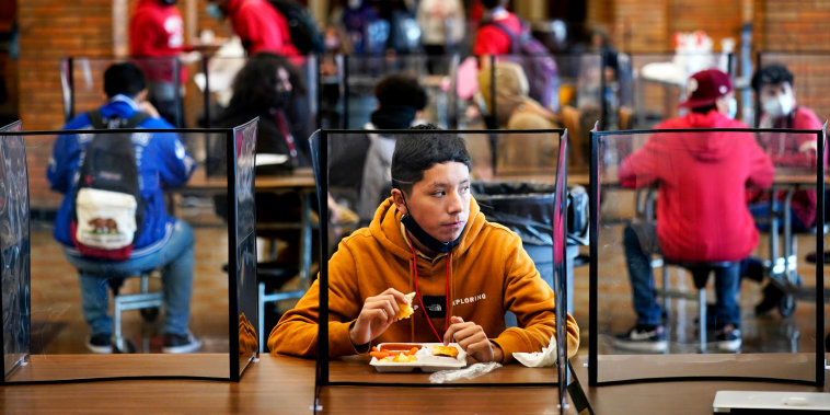 Students eat lunch at Wyandotte County High School in Kansas City, Kan., on March 31, 2021.