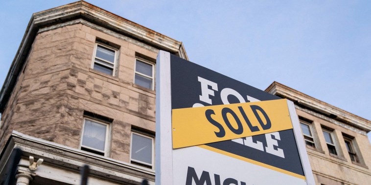 A sold banner is displayed over a For Sale sign in front of a house in Washington, D.C, on March 14, 2022.