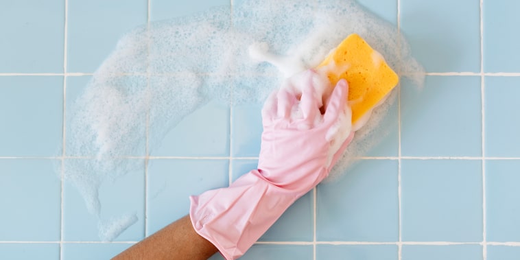 Hand in pink glove with sponge washing