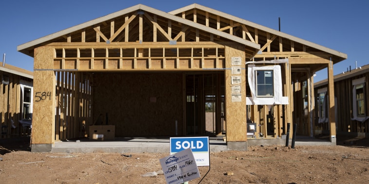 Image: A "Sold" sign outside a new home under construction in Tucson, Arizona on Feb. 22, 2022.