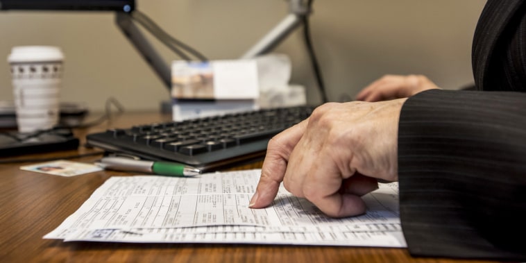 A tax advisor looks over paperwork