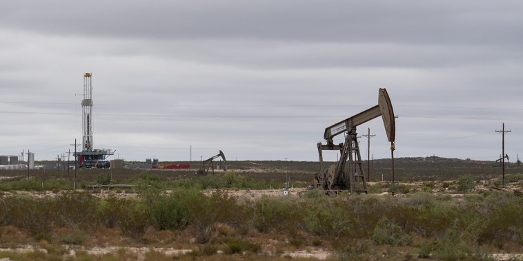 Image: A horizontal drilling rig and a pump jack sit on federal land in Lea County, N. M., on Sept. 10, 2020.