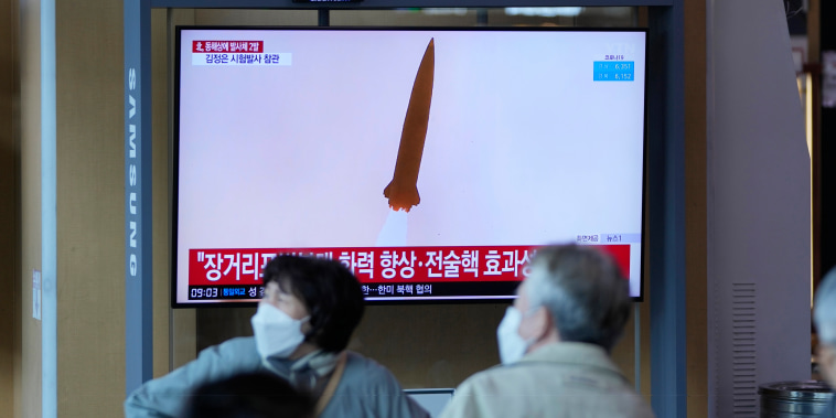 A TV screen shows a news program reporting about a test-firing of a newly developed tactical guided weapon, at a train station in Seoul, South Korea, Sunday, April 17, 2022.