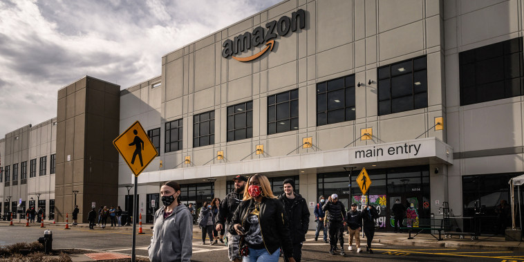 Workers walk to cast their votes over whether or not to unionize, outside an Amazon warehouse in Staten Island on March 25, 2022.