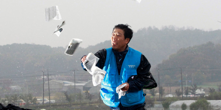 Park Sang-hak, a North Korean refugee who launched balloons carrying propaganda balloons toward North Korea for years, hurls anti-North Korea leaflets in Paju, South Korea in Oct. 2012.