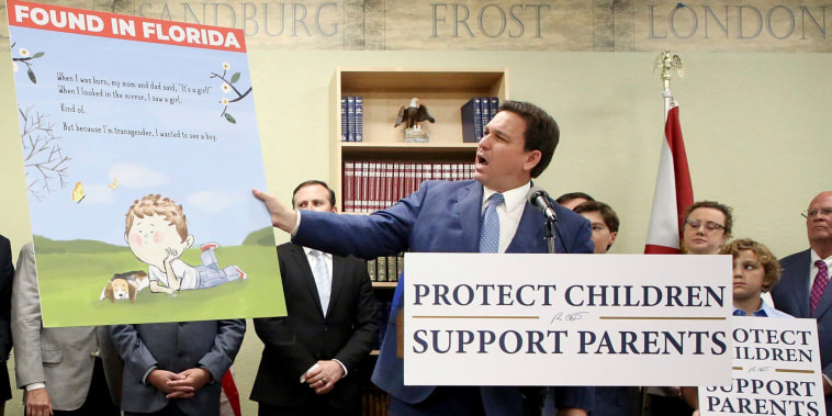 Florida Gov. Ron DeSantis shows an image from the children's book Call Me Max by transgender author Kyle Lukoff moments before signing the Parental Rights in Education bill during a news conference on Monday, March 28, 2022, at Classical Preparatory school in Shady Hills.