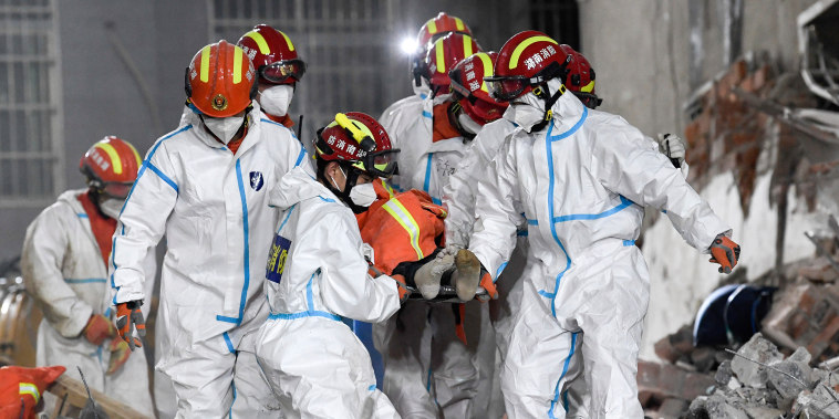 Rescue workers evacuate the 10th survivor pulled alive after being trapped 132 hours from the debris of a self-built residential structure that collapsed in Changsha in central China's Hunan Province, on May 5, 2022.