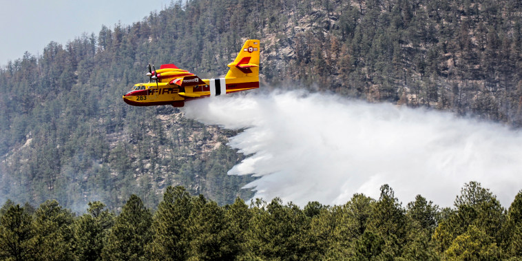 An aircraft known as a "super scooper" battles the Hermits Peak and Calf Canyon Fires in the Santa Fe National Forest in New Mexico on April 28, 2022.