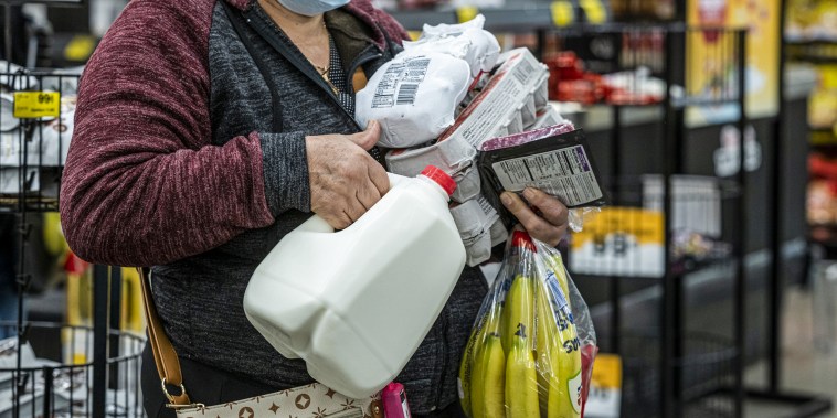 A shopper holds groceries while waiting to check out inside a grocery store in San Francisco on May 2, 2022.