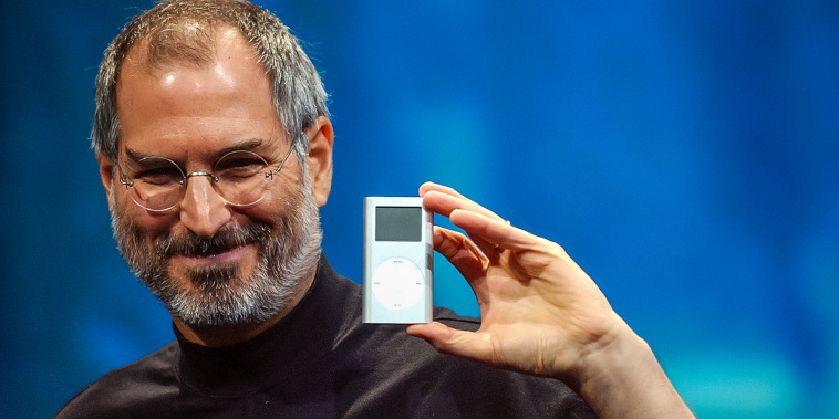 Apple CEO Steve Jobs displays the iPod mini at the Macworld Conference and Expo in San Francisco on Jan. 6, 2004.