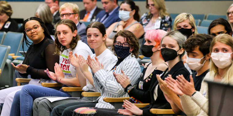 Lyman High School students, with students from other Seminole County high schools, applaud remarks supporting their position during a meeting of the Seminole County School Board on May 10, 2022, in Seminole County, Fla.