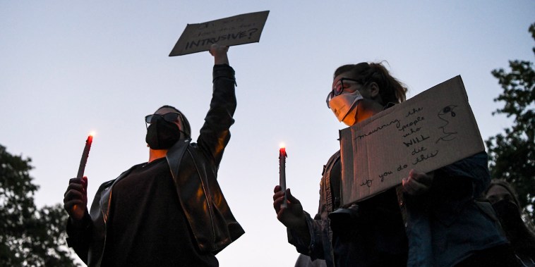 Image: Demonstrators march to Justice Samuel Alito's house for a candlelight vigil as part of an abortion rights protest in Alexandria, Va., on Monday, May 9, 2022.  (Kenny Holston/The New York Times)