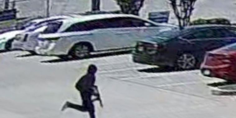 Surveillance footage shows a suspected shooter fleeing a salon in Dallas after opening fire, injuring 3 people on May 11, 2022.
