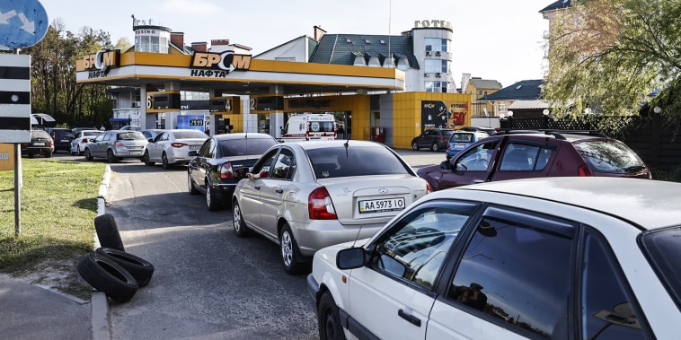 Drivers line up in long queues at a gas station amid the fuel supply cutoff in Kyiv on May 11, 2022.
