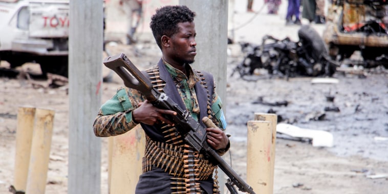 A Somali soldier secures the area after a car bomb attack at a presidential palace checkpoint in Mogadishu, Somalia, on Sept. 25, 2021.