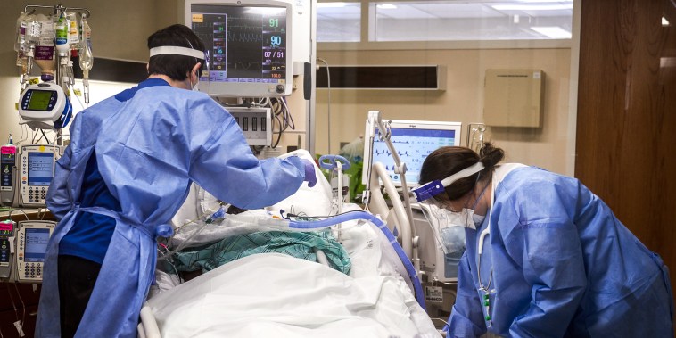 Healthcare workers treat a Covid-19 patient on the Intensive Care Unit floor at Hartford Hospital in Hartford, Conn., on Jan. 31, 2022.