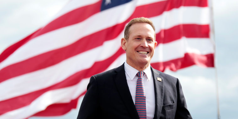 Republican senate candidate Ted Budd smiles as he takes the stage before former President Donald Trump speaks on April 9, 2022, in Selma, N.C.