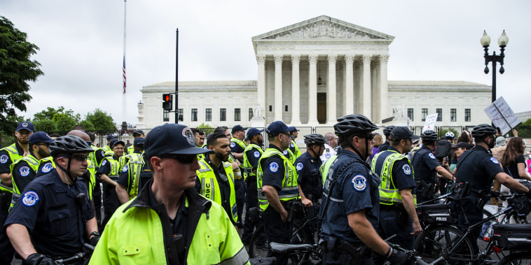 Police stand outside the Supreme Court building during a nationwide rally in support of abortion rights on May 14, 2022.