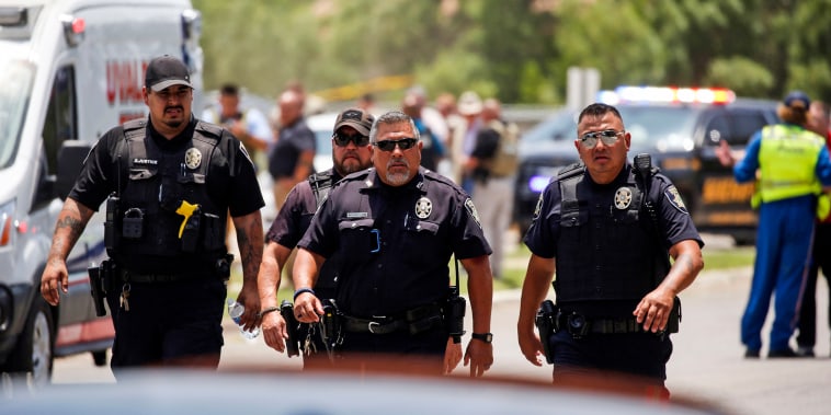 Police walk near Robb Elementary School following a shooting on May 24, 2022, in Uvalde, Texas.