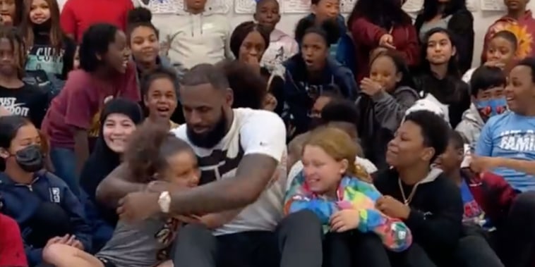 LeBron James hugs students at his I Promise School after he surprises them on their last day of class.