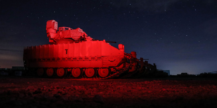 U.S. Soldiers from the 2nd Platoon, Alpha Company, 1/163rd Combined Arms Battalion, unload M2A3 Bradley Fighting Vehicles off a U.S. Air Force C-17 Globemaster in northeast Syria on Jan. 31, 2022.