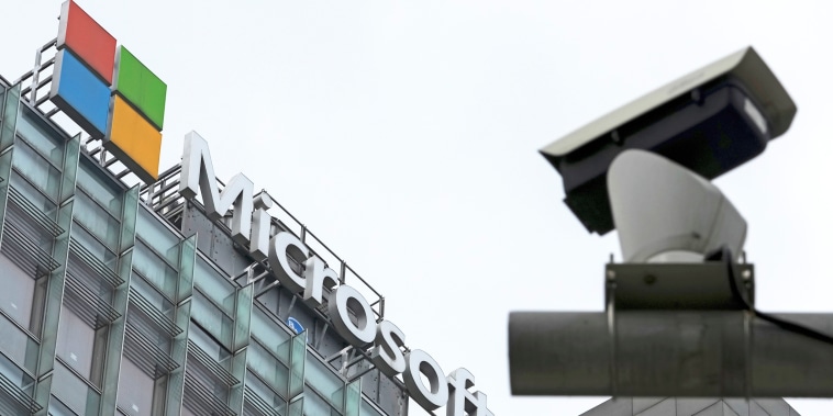 A security surveillance camera sits mounted near the Microsoft office building in Beijing on July 20, 2021.