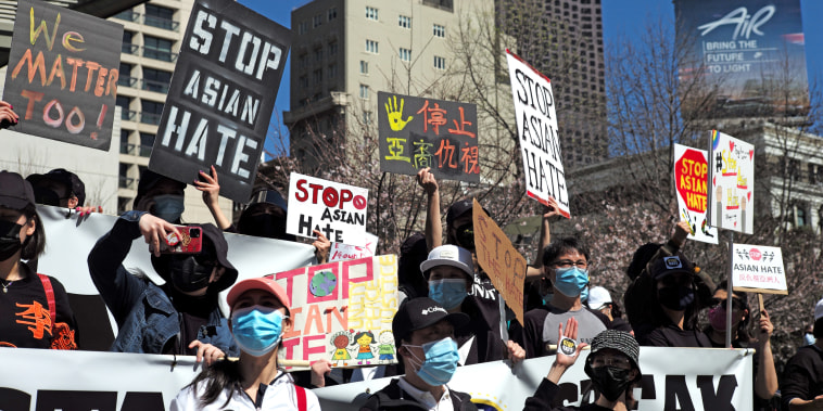 People take part in a rally against racism and violence on Asian Americans