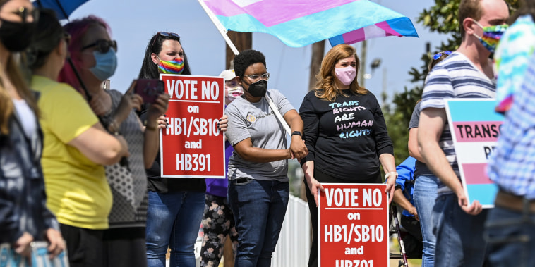 Opponents of several bills targeting transgender youth attend a rally at the Alabama State House in Montgomery, on March 30, 2021.