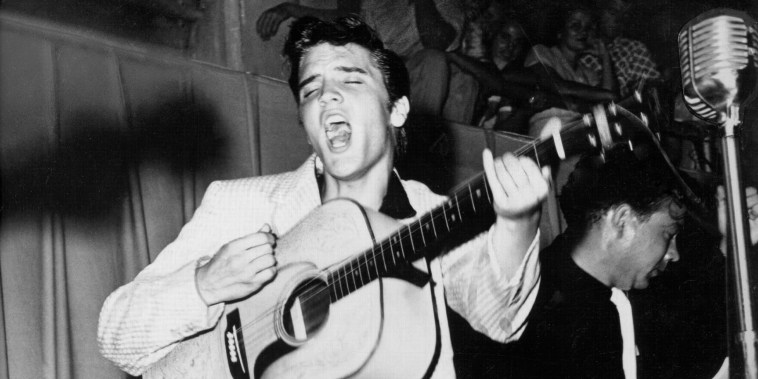 TAMPA, FL - JULY 31: Rock and roll singer Elvis Presley performs on stage with his brand new Martin D-28 acoustic guitar on July 31, 1955 at Fort Homer Hesterly Armory in Tampa, Florida. (Photo by Michael Ochs Archives/Getty Images)