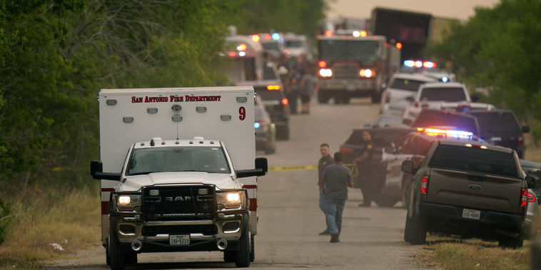 An ambulance leaves the scene where police said dozens of people were found dead in a semitrailer in a remote area in southwestern San Antonio, Monday, June 27, 2022.