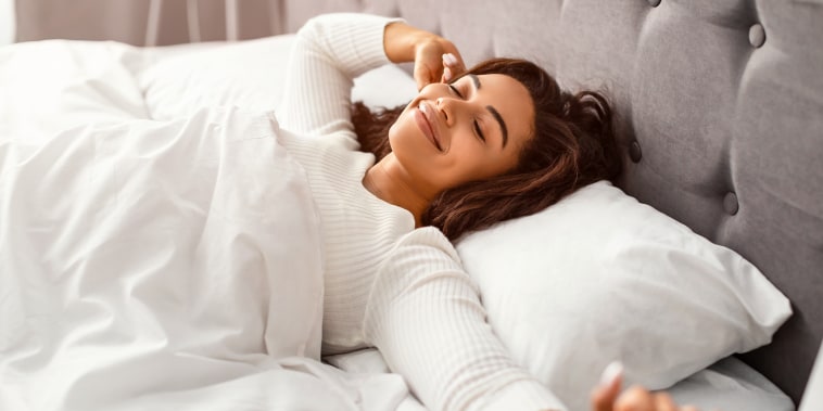 woman waking up with smile on her face
