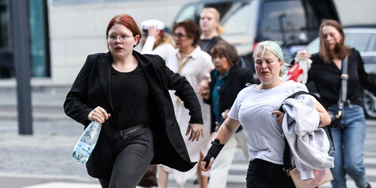 People run following a shooting at the Fields shopping center in Copenhagen, Denmark, on July 3, 2022.