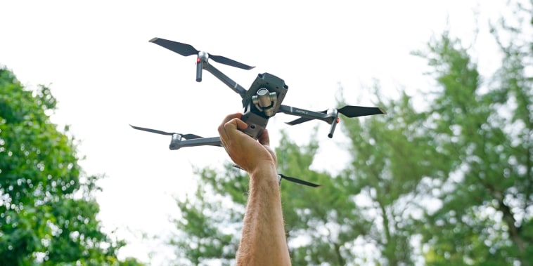 A man holds a drone with his hand