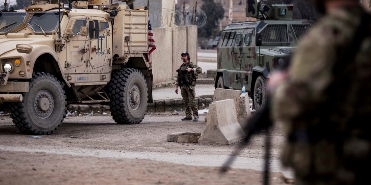 US soldiers stand guard in Hassakeh, northeast Syria, on Jan. 27, 2022.