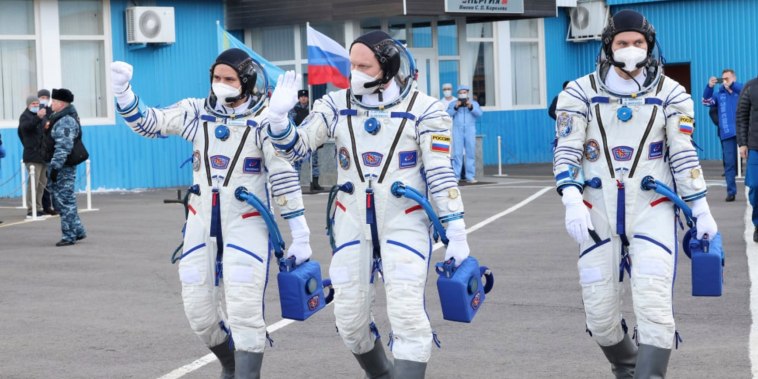 Russian cosmonauts, commander Оleg Аrtemyiv, centre, flight engineers Denis Мatveev, right, and Sergei Korsakov, members of the main crew to the International Space Station (ISS), walk prior to the launch at the Baikonur Cosmodrome, Kazakhstan, on March 18, 2022.