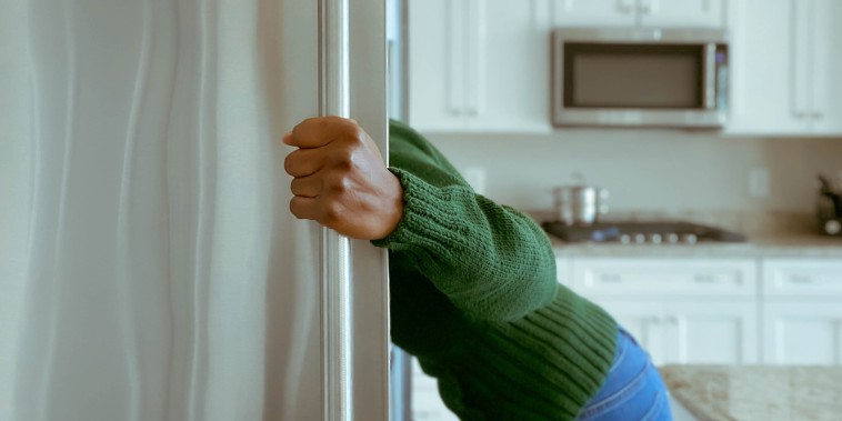 Woman Looks into Refrigerator for Healthy Snack