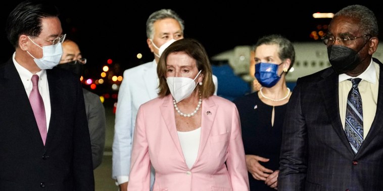 House Speaker Nancy Pelosi arrives in Taiwan as she is welcomed by Taiwan Foreign Minister Joseph Wu, left, at Taipei Songshan International Airport on Aug. 2, 2022.