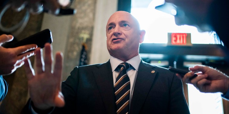 Sen. Mark Kelly talks with reporters in the Capitol on July 27, 2022.