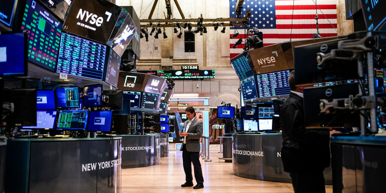Traders work on the floor at the New York Stock Exchange in New York on Aug. 10, 2022.