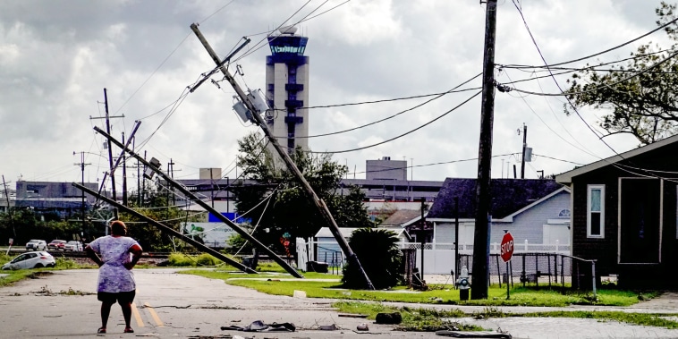 A woman looks over damage to a neighborhood caused by Hurricane Ida on Aug. 30, 2021 in Kenner, La.