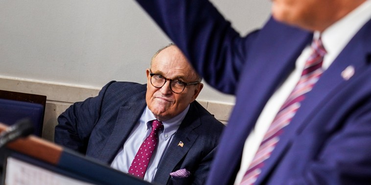Former New York Mayor Rudy Giuliani listens as President Donald Trump speaks in the Briefing Room of the White House on Sept. 27, 2020.