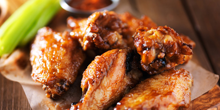 barbecue chicken wings close up on wooden tray