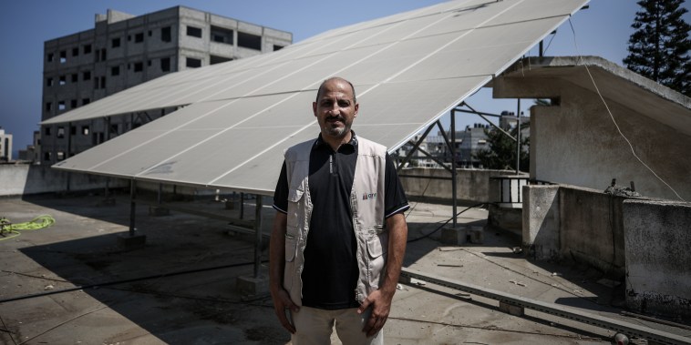 Sami Matar, next to vital solar panels on the roof of the Blood Bank Society in Gaza City on Aug. 20, 2022.