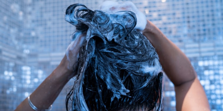 Close-up of woman washing her hair in bathroom
