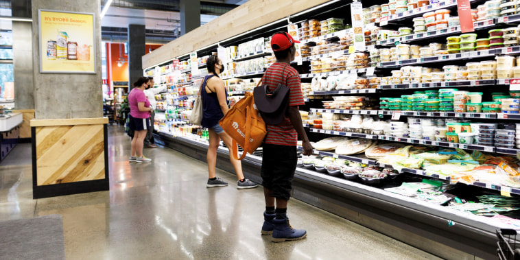Customers shop at a supermarket