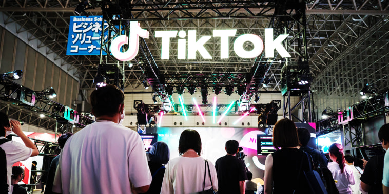 Attendees stand outside the TikTok booth