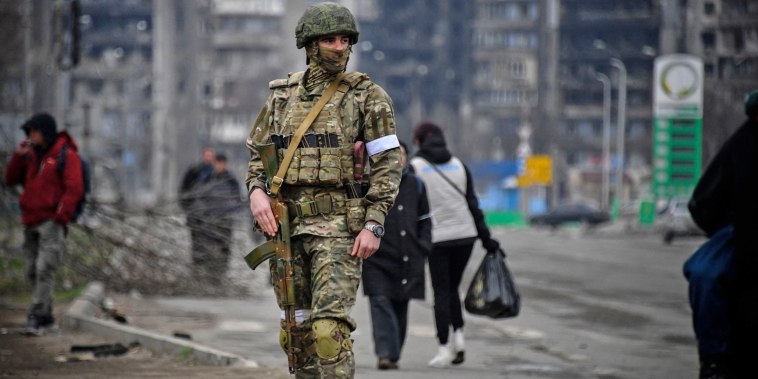 A Russian soldier patrols in Mariupol, Ukraine