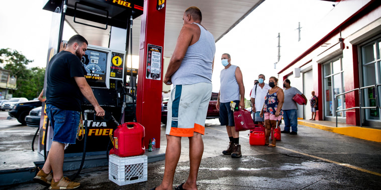 People wait in line at the Top Fuel gas station to fill their tanks on Sept. 20, 2022, in Cabo Rojo, Puerto Rico.