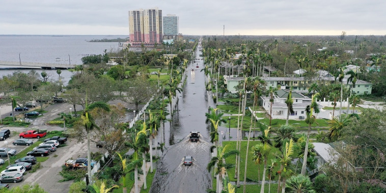 Image: An aerial view of vehicles making their way through a flooded area after Hurricane Ian passed through the area in Fort Myers, Fla.